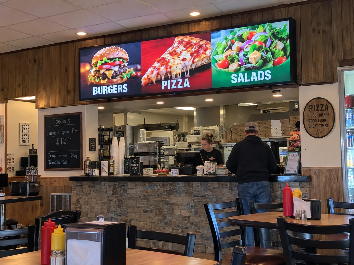 Indoor restaurant LED menu display Wide indoor LED menu display above a restaurant service counter